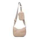 The Joss Crossbody is a woven straw bag with a beige adjustable strap and a small matching pouch—perfect for stylish everyday outings.