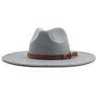 The Bethie Belted Wool Panama Hat is a light gray wide-brimmed fedora with a brown leather band and small bow detail around the crown, shown on a white background.